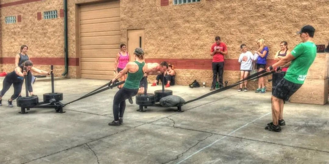 StrongFit class with sandbags, sleds, and heavy carries