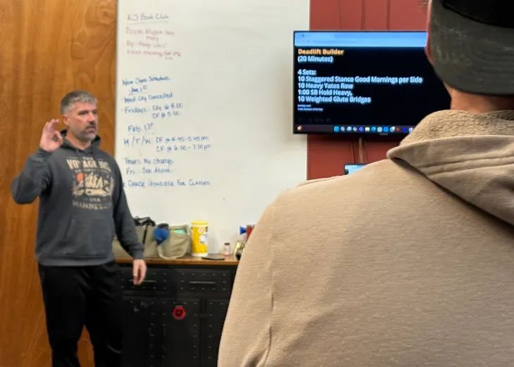 KJ Health Collective coach instructing and supporting a group class
